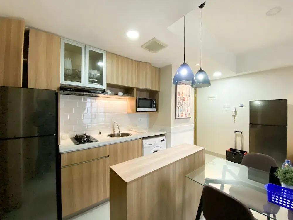 Cozy and Minimalist 2BR at 8th Floor The Oasis Cikarang Apartment By Travelio