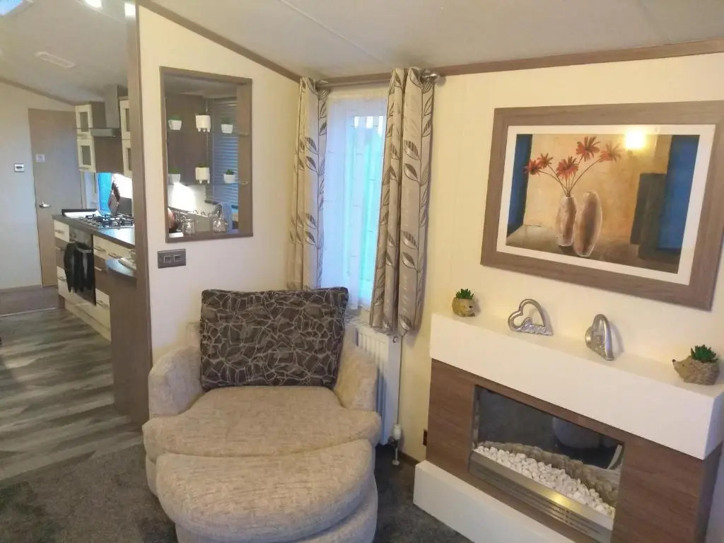 E3 is a 2 Bedroom 6 berth Lodge on Whitehouse Leisure Park in Towyn near Rhyl with Free WiFi, decking and private parking space