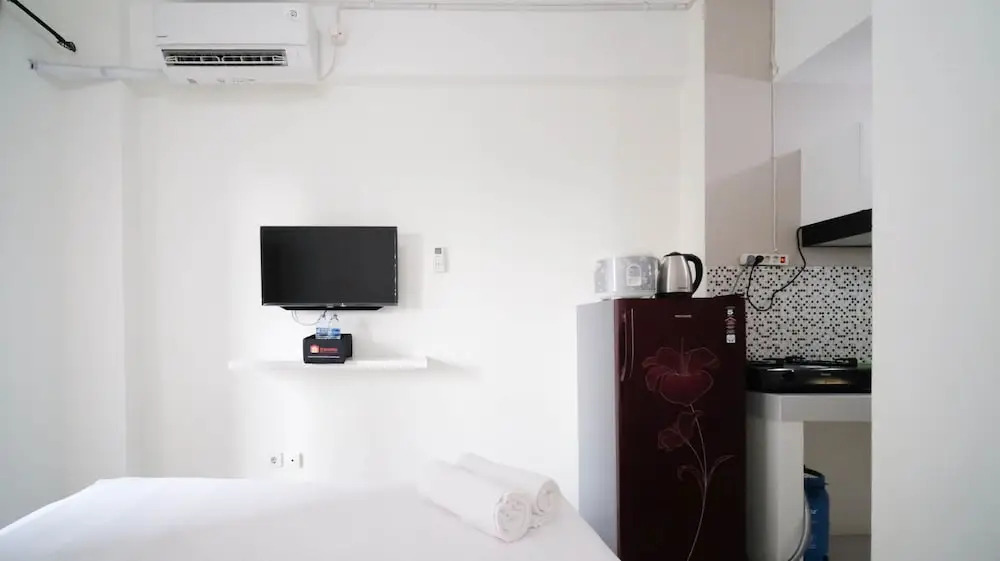 Compact and Tidy Studio at Puncak Dharmahusada Apartment By Travelio