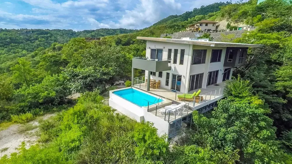 Modern Hillside Home with Sleek Interiors and Panoramic Poolside Views