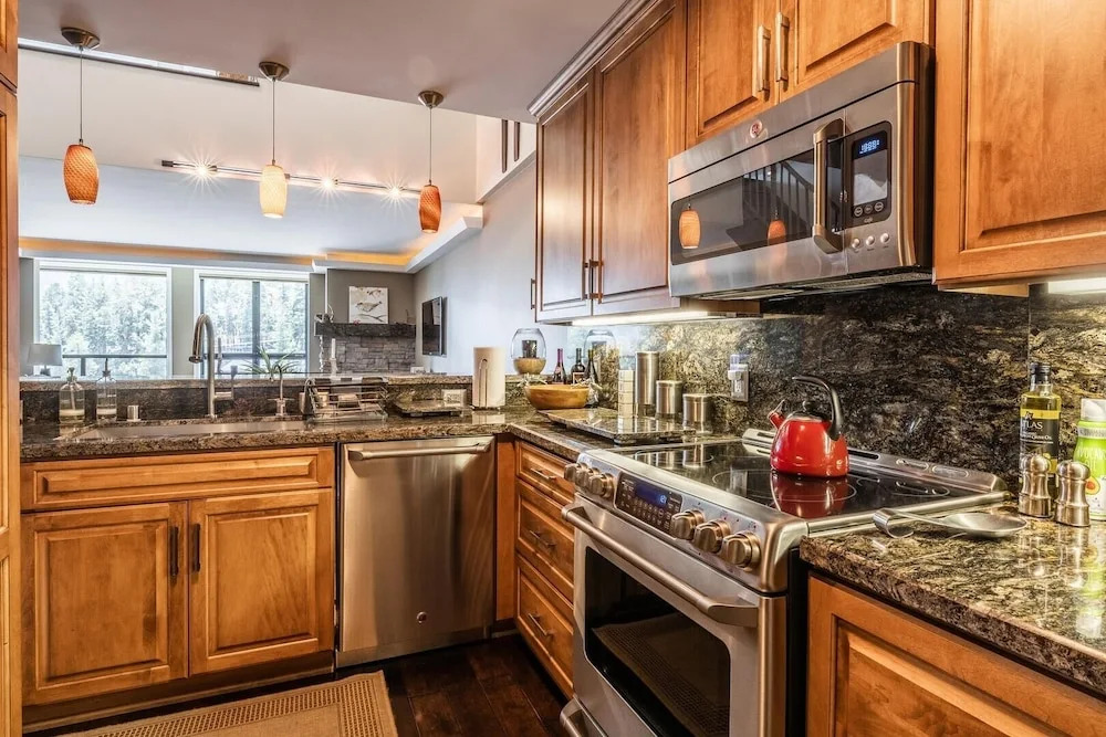 DELUXE SLOPESIDE Condo with 4th FLOOR VIEWS, Elevator and Underground Parking at Canyon Lodge (1849 Condos 409) by RedAwning