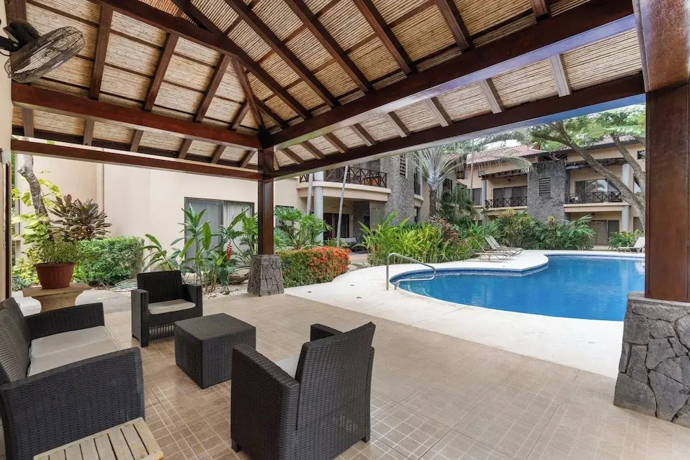 Modern Island-Themed Condo with Floor-to-Ceiling Windows & Garden and Pool Views Within Walking Distance of the Beach