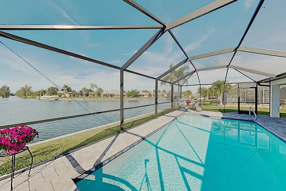 Impeccable Canal-front W/ Lanai & Caged Pool 4 Bedroom Home