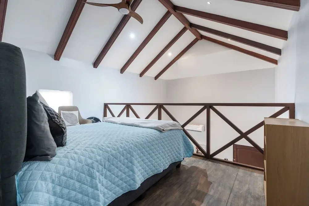 Modern Island-Themed Condo with Floor-to-Ceiling Windows & Garden and Pool Views Within Walking Distance of the Beach