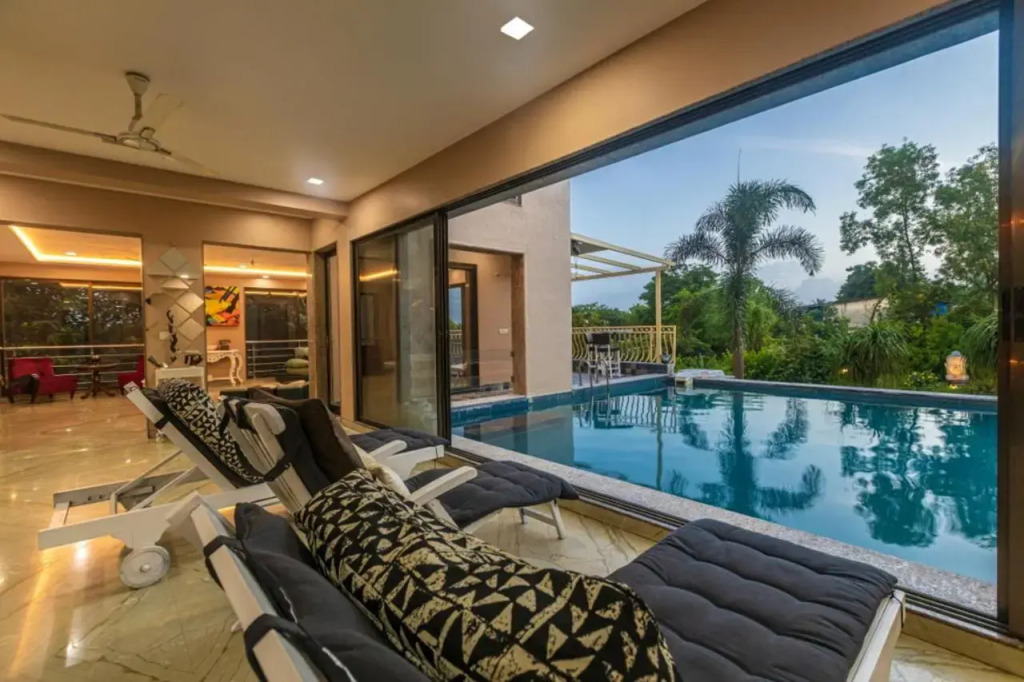 SaffronStays Aura - 4BR luxury pool villa with gym, BBQ deck, lawns & indoor games near Kihim Beach