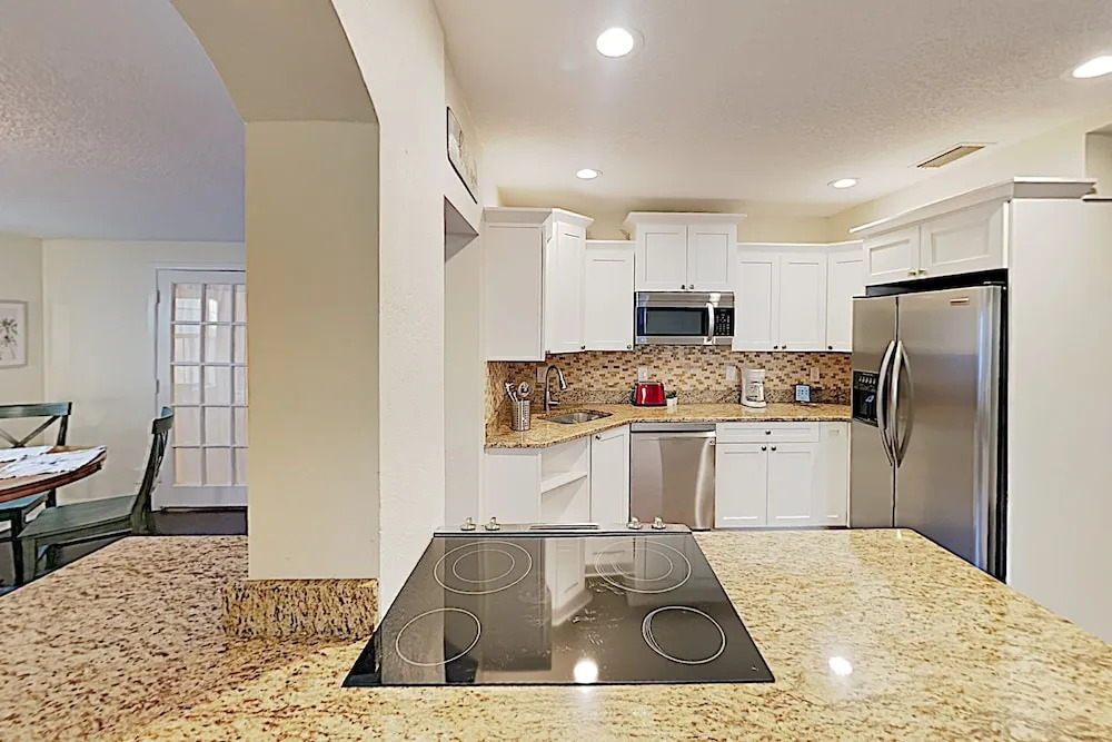 Updated W/ Gated Pool & Screened-in Porch 4 Bedroom Home