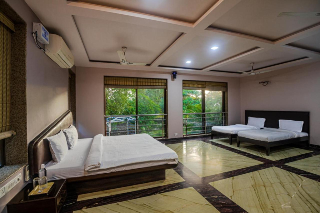 SaffronStays Aura - 4BR luxury pool villa with gym, BBQ deck, lawns & indoor games near Kihim Beach