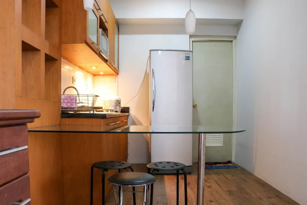 Cozy Living and Modern 2BR Puri Garden Apartment By Travelio