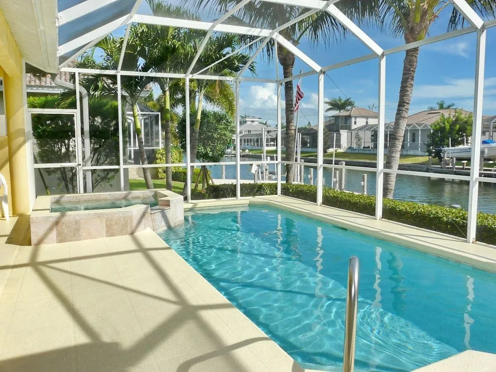 Large waterfront home with all-day sun on pool