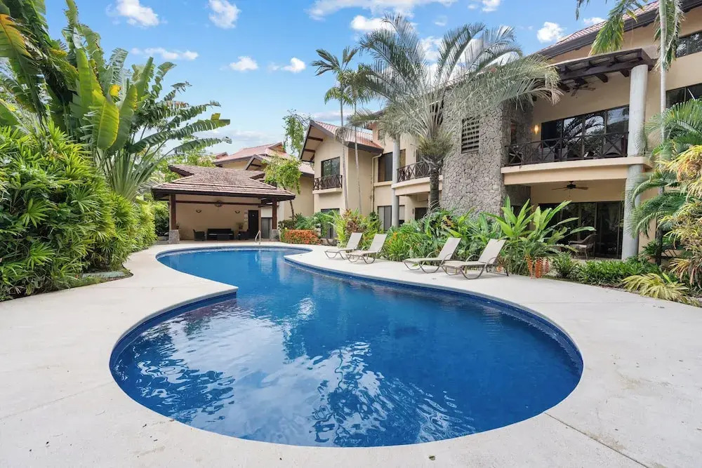 Modern Island-Themed Condo with Floor-to-Ceiling Windows & Garden and Pool Views Within Walking Distance of the Beach