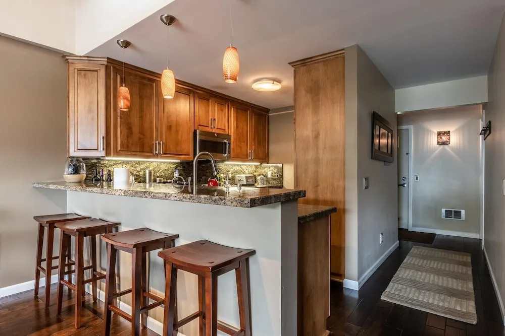 DELUXE SLOPESIDE Condo with 4th FLOOR VIEWS, Elevator and Underground Parking at Canyon Lodge (1849 Condos 409) by RedAwning