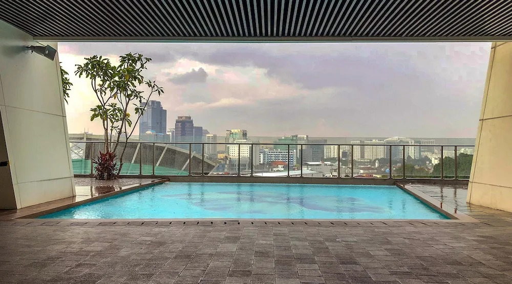 Comfy Studio Room with City View at Menteng Park Apartment By Travelio