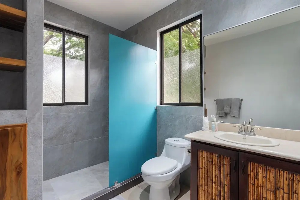 Modern Island-Themed Condo with Floor-to-Ceiling Windows & Garden and Pool Views Within Walking Distance of the Beach