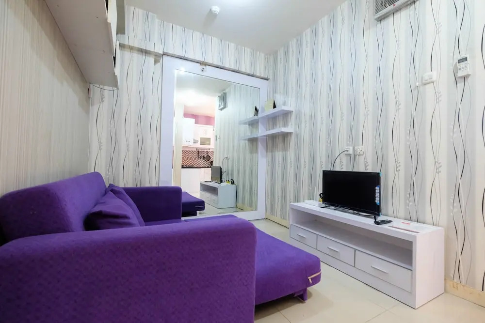 Homey 1BR with Spacious Living Room and Sofa Bed Green Pramuka Apartment