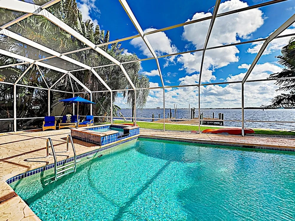 Riverfront Paradise W/ Caged Pool, Hot Tub & Dock 3 Bedroom Home