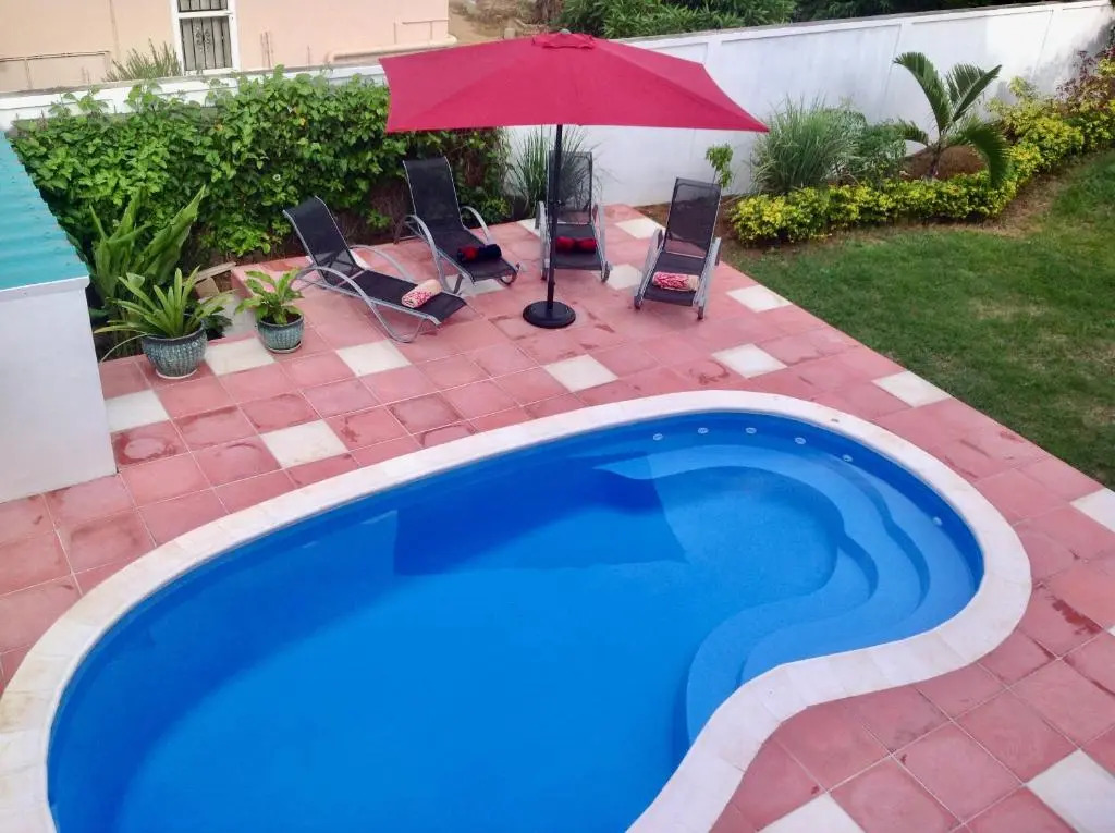 Cardamon Villa is a 2 bedroom with 1 bathroom and seperate toilet detached house with AC and swimming pool , 5 minutes walk from Flic en Flac public beach