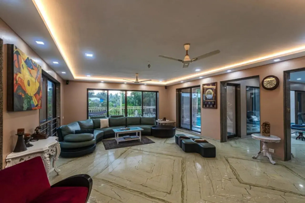 SaffronStays Aura - 4BR luxury pool villa with gym, BBQ deck, lawns & indoor games near Kihim Beach