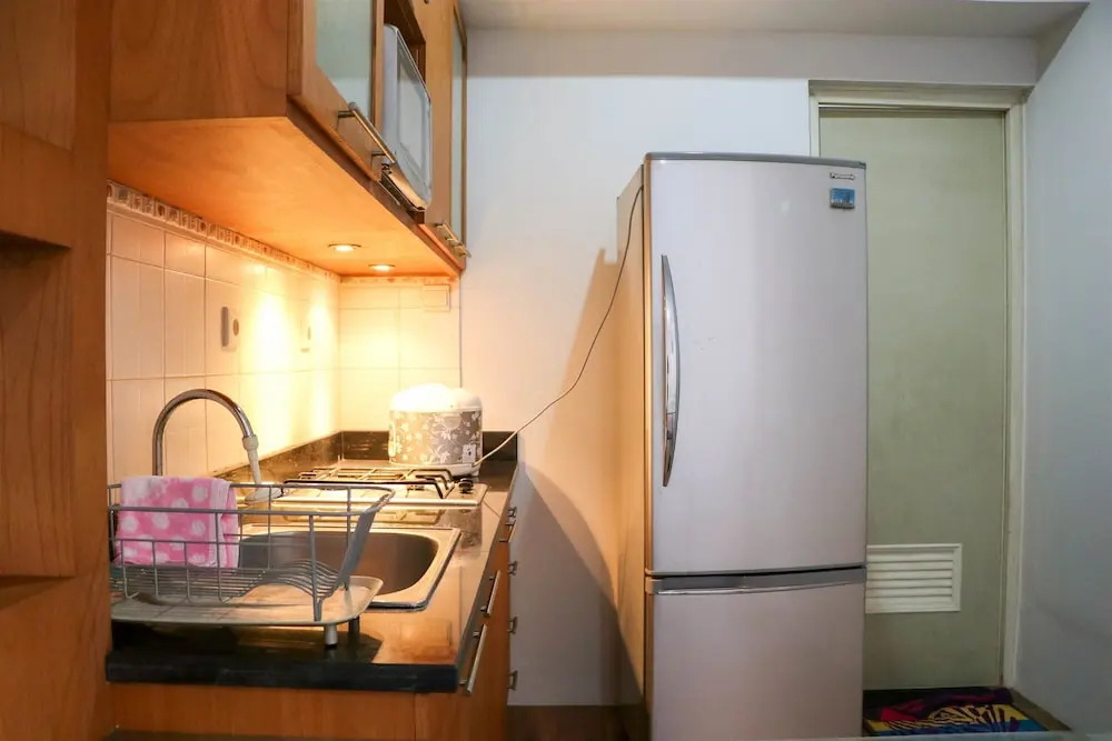 Cozy Living and Modern 2BR Puri Garden Apartment By Travelio