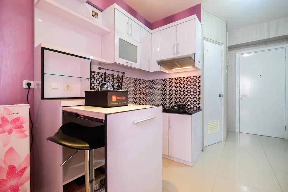 Homey 1BR with Spacious Living Room and Sofa Bed Green Pramuka Apartment