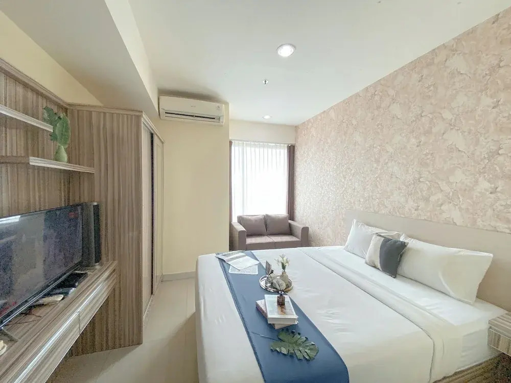 Modern and Homey 1BR without Living Room at Grand Kamala Lagoon Apartment By Travelio