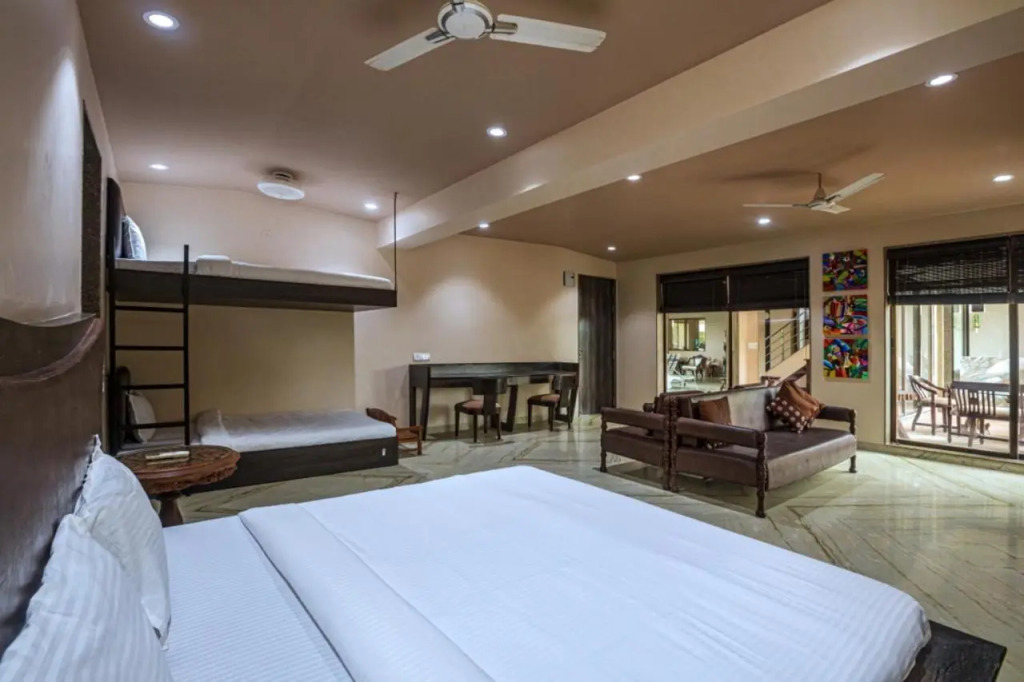SaffronStays Aura - 4BR luxury pool villa with gym, BBQ deck, lawns & indoor games near Kihim Beach