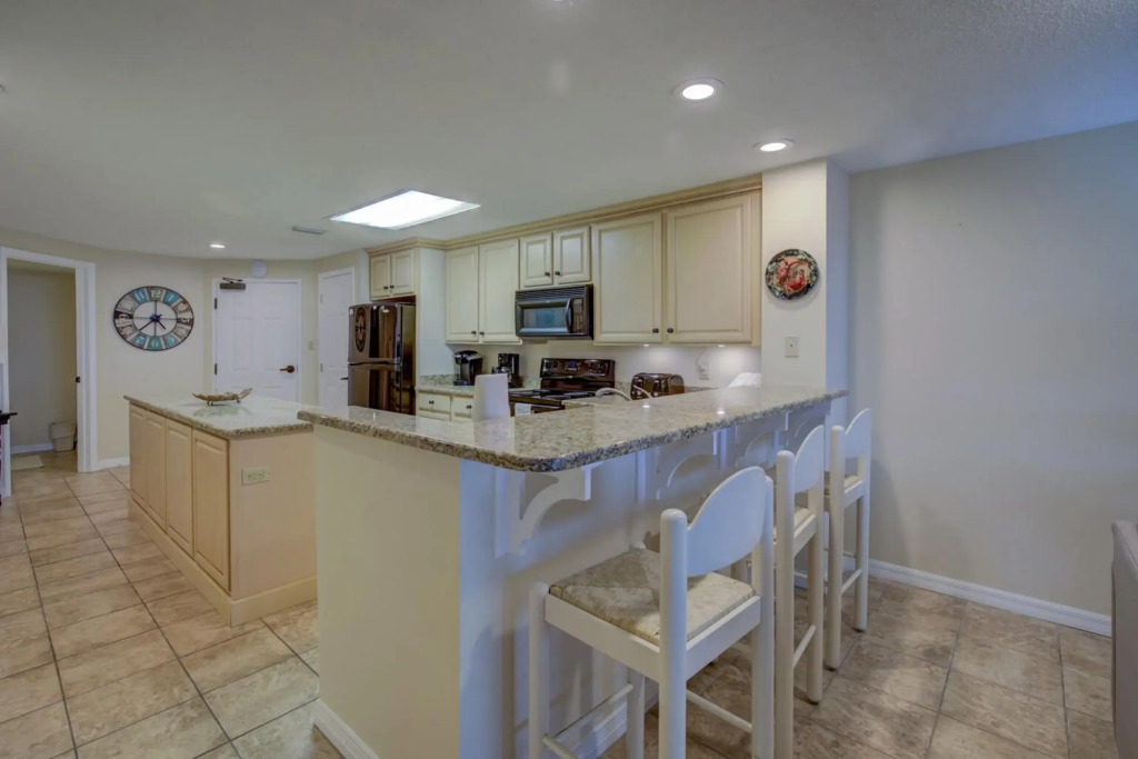Stunning ground floor condo with lush lawn overlooking white sands