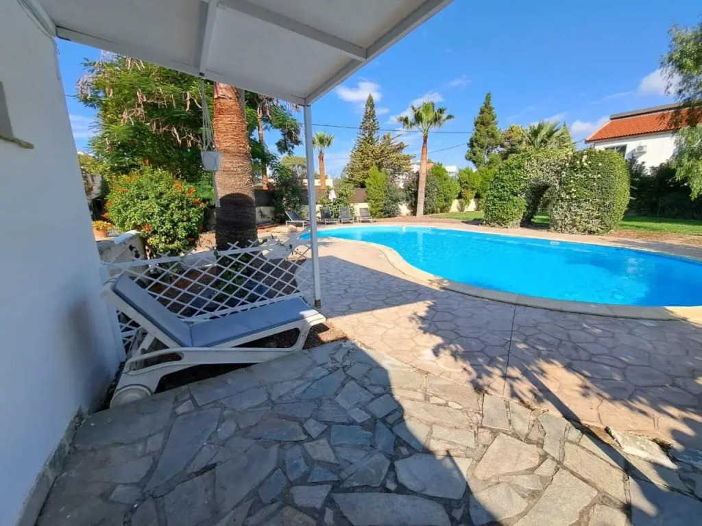 Mediterranean poolside garden cottage