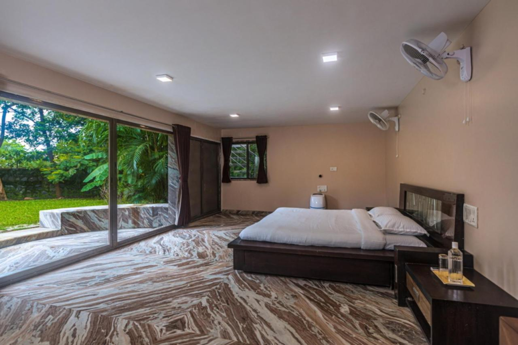 SaffronStays Aura - 4BR luxury pool villa with gym, BBQ deck, lawns & indoor games near Kihim Beach