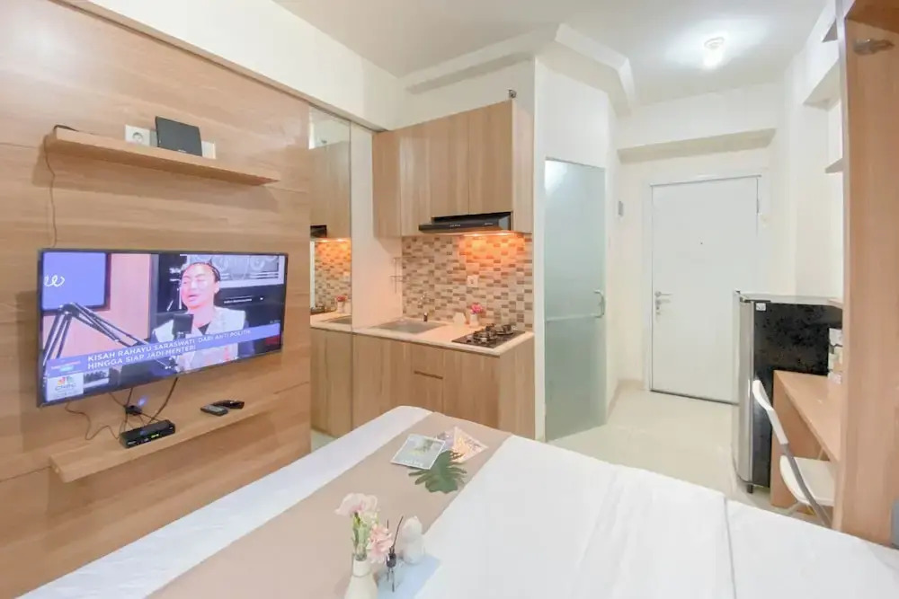 Warm and Well Designed Studio Room at Green Pramuka City Apartment