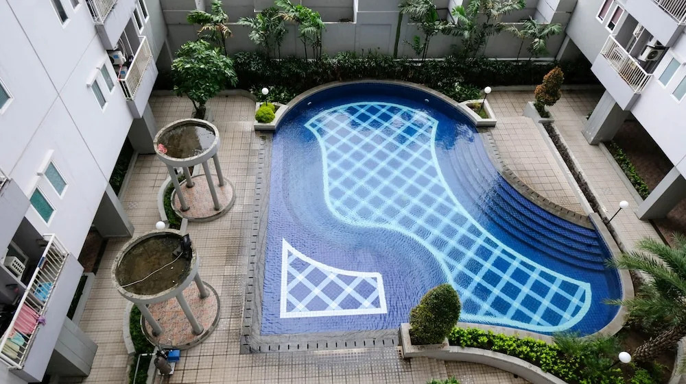Cozy Living And Tidy 2Br At Puncak Dharmahusada Apartment