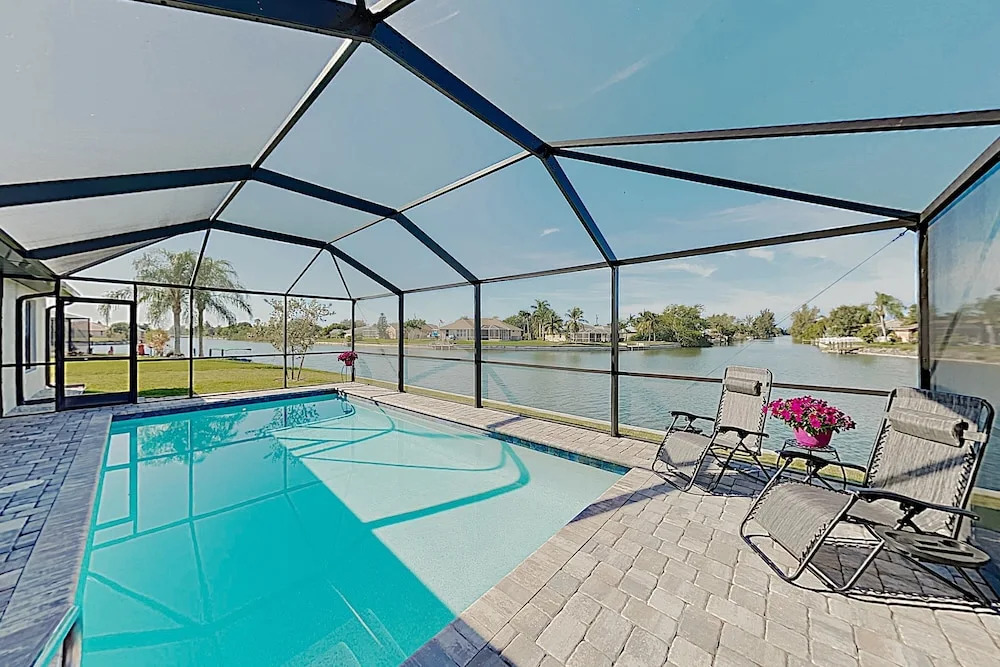 Impeccable Canal-front W/ Lanai & Caged Pool 4 Bedroom Home