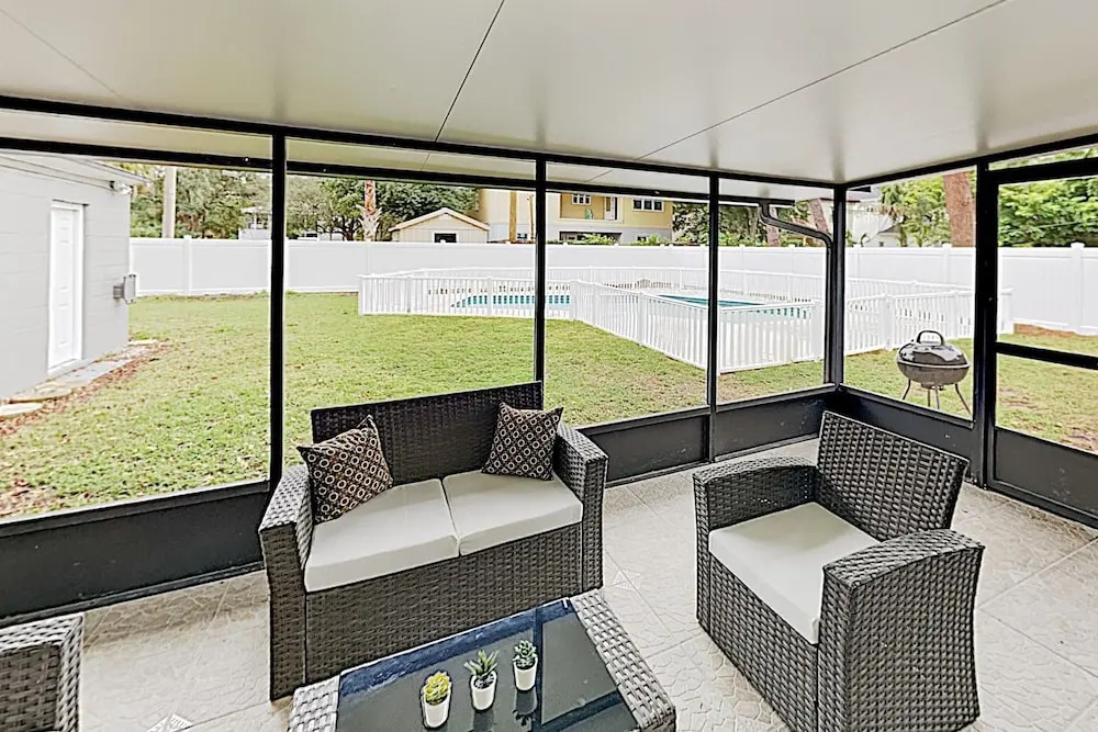 Updated W/ Gated Pool & Screened-in Porch 4 Bedroom Home