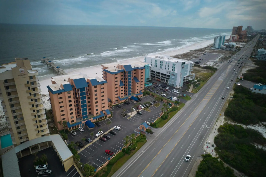 Stunning ground floor condo with lush lawn overlooking white sands