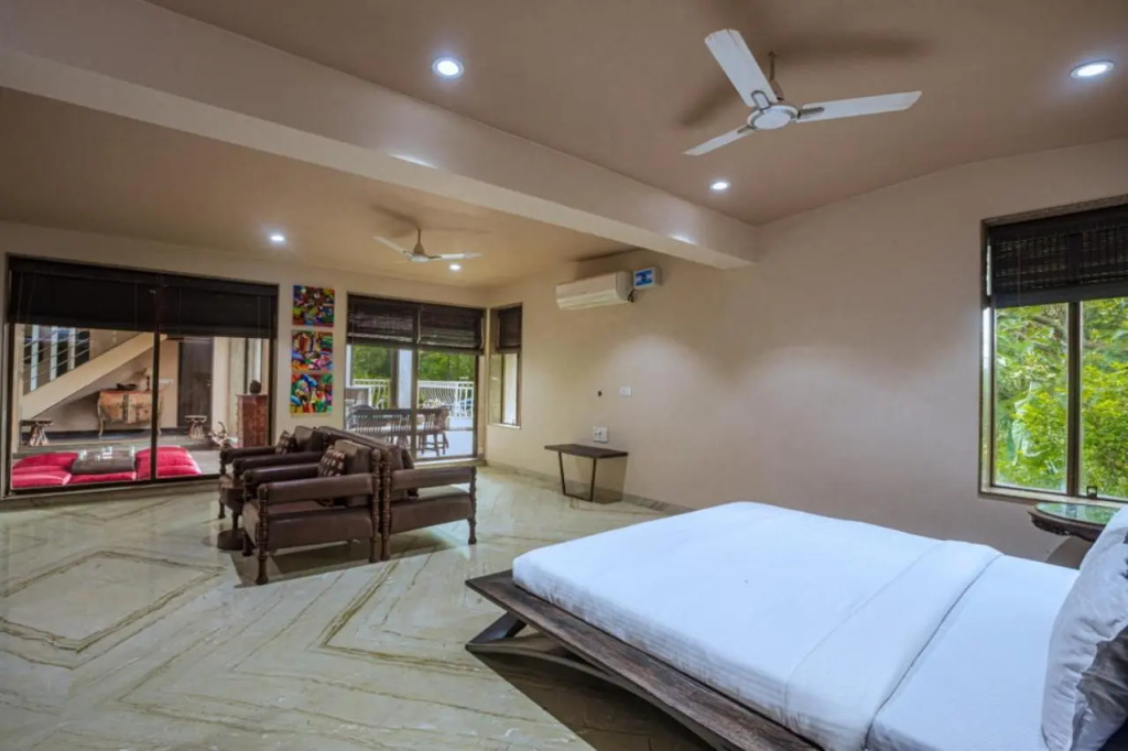 SaffronStays Aura - 4BR luxury pool villa with gym, BBQ deck, lawns & indoor games near Kihim Beach