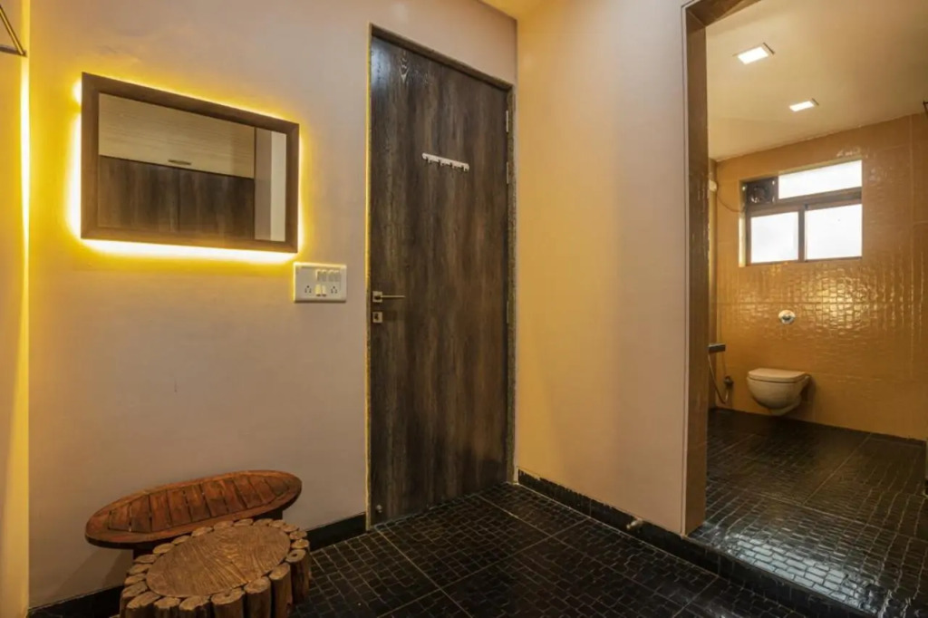 SaffronStays Aura - 4BR luxury pool villa with gym, BBQ deck, lawns & indoor games near Kihim Beach