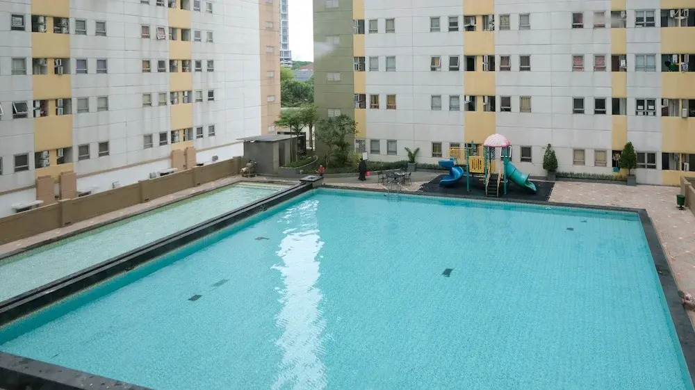 Homey 2BR at Puncak Permai Apartment By Travelio