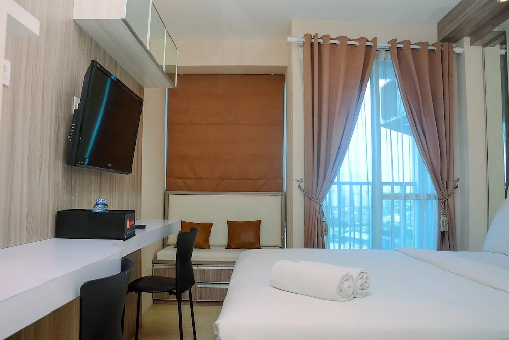 Homey and Cozy Living Studio Room at Tifolia Apartment By Travelio