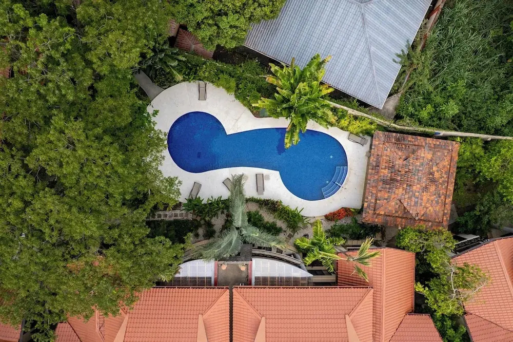Modern Island-Themed Condo with Floor-to-Ceiling Windows & Garden and Pool Views Within Walking Distance of the Beach
