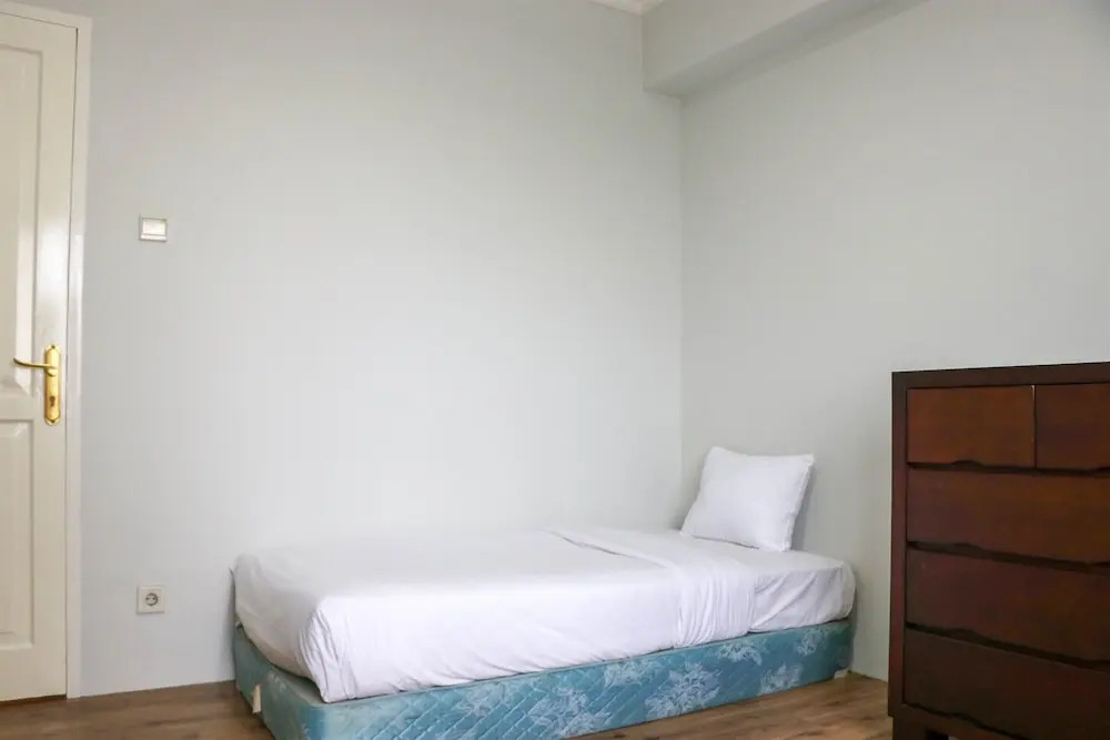Cozy Living and Modern 2BR Puri Garden Apartment By Travelio