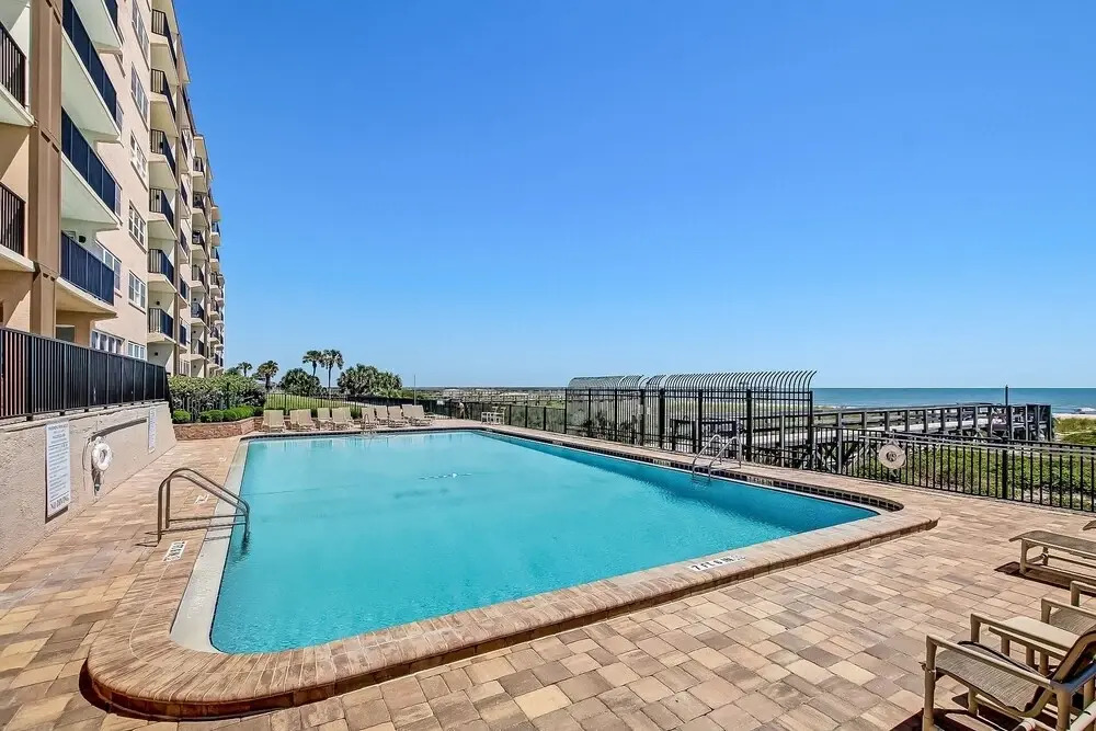 Oceanfront Beach Condo with Private Balcony, Short Walk to Pool and Beach by RedAwning