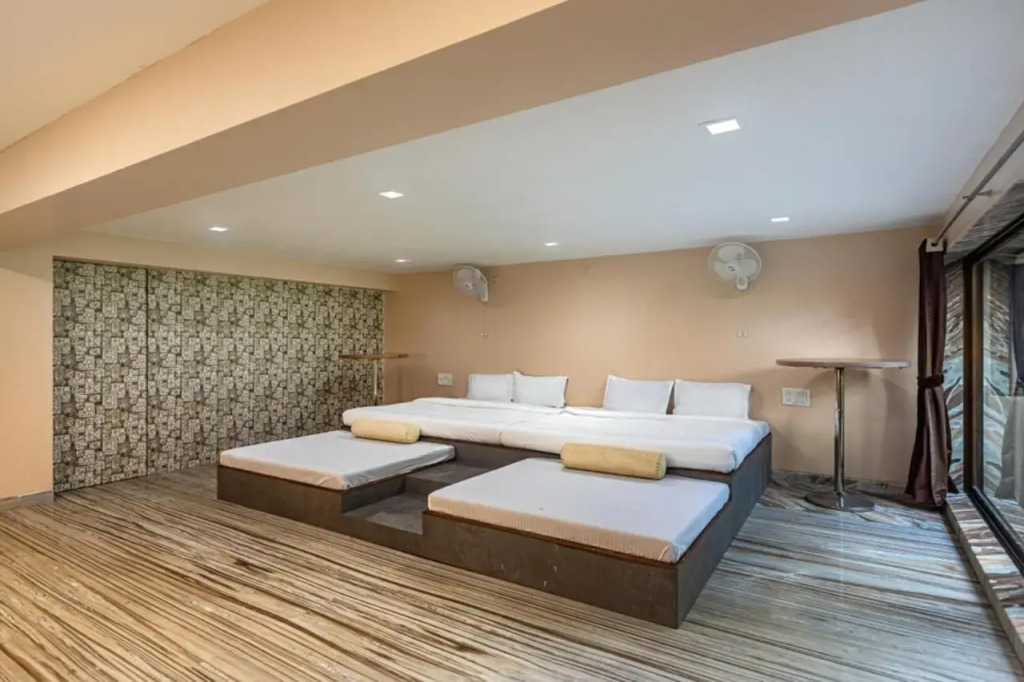 SaffronStays Aura - 4BR luxury pool villa with gym, BBQ deck, lawns & indoor games near Kihim Beach