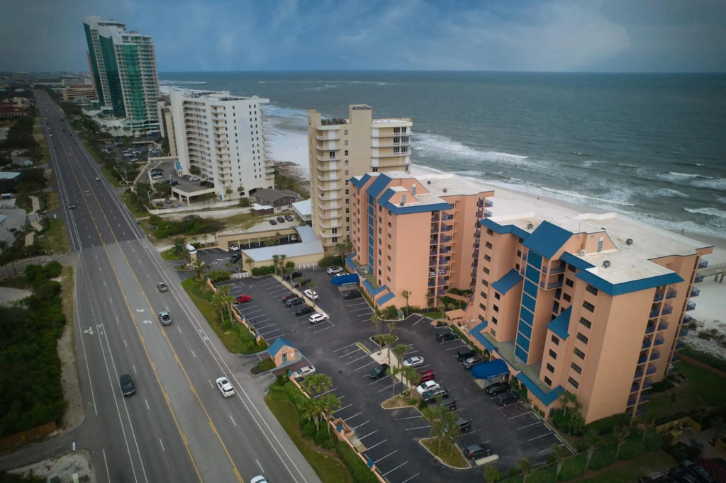 Stunning ground floor condo with lush lawn overlooking white sands