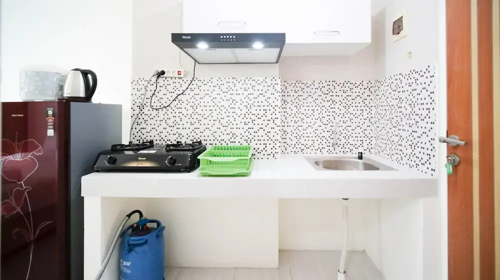 Compact and Tidy Studio at Puncak Dharmahusada Apartment By Travelio