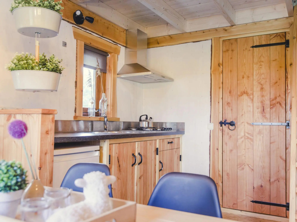 Beautiful wooden tree house with terrace in a holiday park on the river De Regge