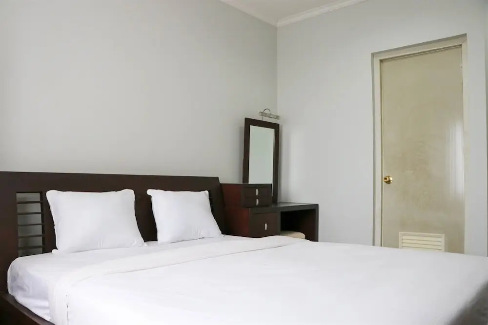 Cozy Living and Modern 2BR Puri Garden Apartment By Travelio