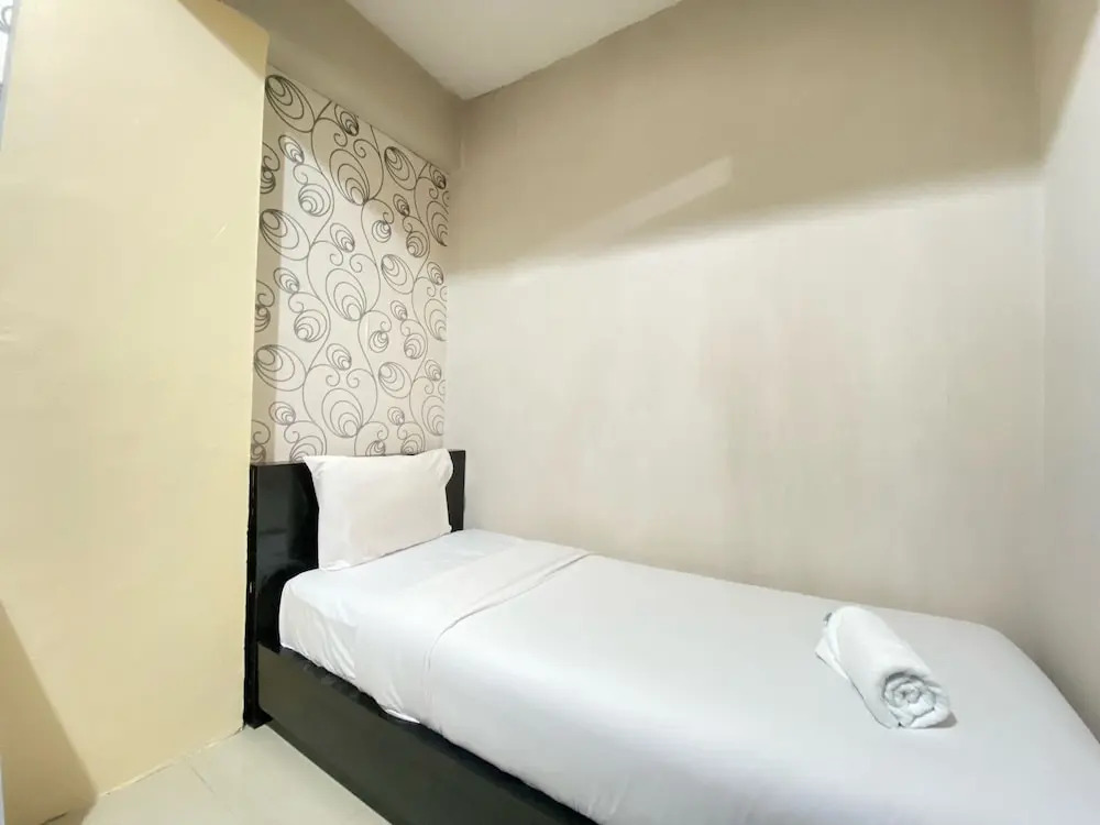 Cozy 2BR at Pinewood Apartment By Travelio