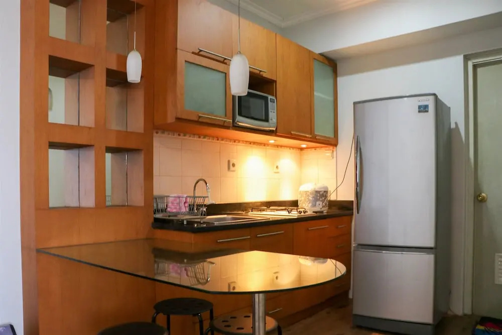Cozy Living and Modern 2BR Puri Garden Apartment By Travelio