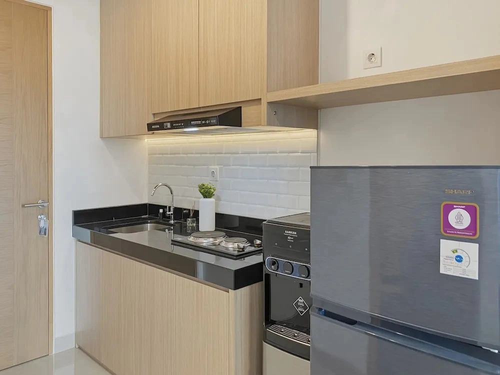 Homey Wooden Touch Studio At Apartment Ciputra World 2