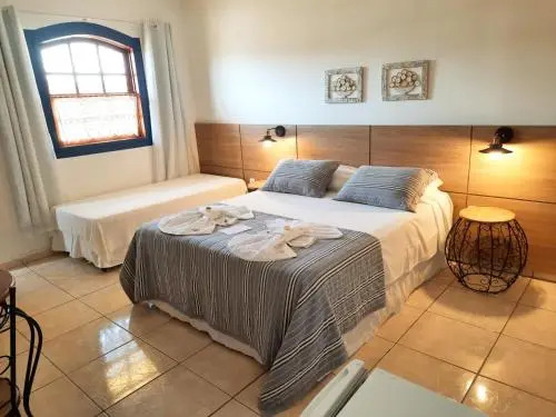 Pousada Luz do Sol, com piscina, quartos amplos e confortáveis no centro de Carrancas
