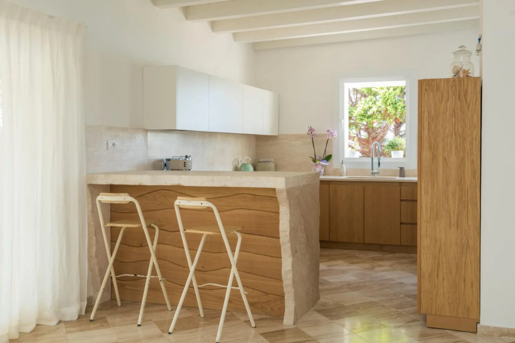 It features a large living area with fully equipped open kitchen and access to the covered terrace d-S'ABBA 1